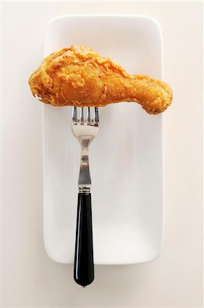 A Fried Drumstick on a Fork Foto de stock - Sin royalties Premium, Código: 659-07026813