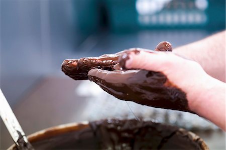 pastrycook - Truffles being rolled in melted chocolate Stock Photo - Premium Royalty-Free, Code: 659-07027114