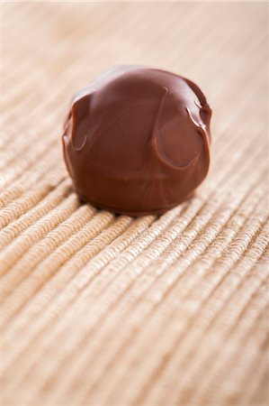 A home-made chocolate truffle coated in milk chocolate Stock Photo - Premium Royalty-Free, Code: 659-07027120