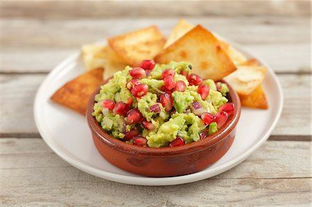 Guacamole with pomegranate seeds and tortilla chips Stock Photo - Premium Royalty-Free, Code: 659-07027258