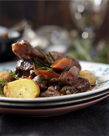 Coq au vin on stacked plates Stock Photo - Premium Royalty-Free, Code: 659-07027342