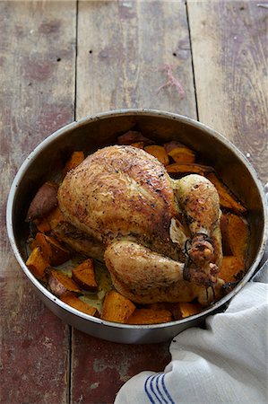 A whole roast chicken with yams Stock Photo - Premium Royalty-Free, Code: 659-07027395