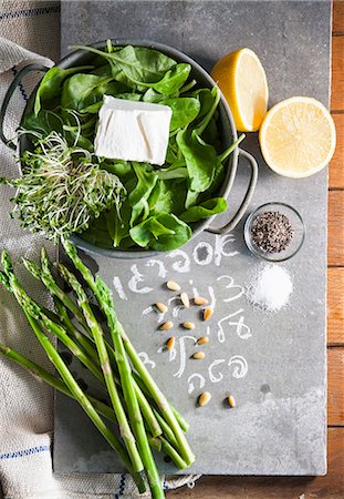 A still life of spinach, asparagus, cress, feta, pine nuts, lemons, salt and pepper Stock Photo - Premium Royalty-Free, Code: 659-07027486