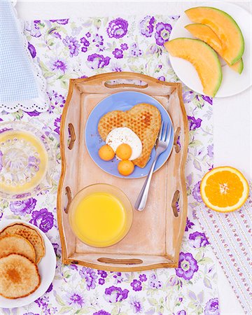 simsearch:659-07959692,k - A breakfast tray with a heart-shaped pancake with yoghurt and melon balls and a glass of orange juice Stock Photo - Premium Royalty-Free, Code: 659-07027707