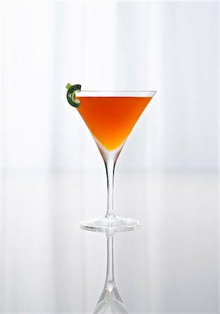 An Orange Cocktail in a Stem Glass on a Reflective Surface Stock Photo - Premium Royalty-Free, Code: 659-07027872