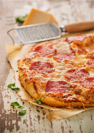 food selective focus - Whole Pepperoni Pizza on White Stock Photo - Premium Royalty-Free, Code: 659-07027996