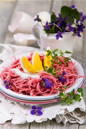 simsearch:659-06188324,k - Beetroot pasta with a boiled egg, herb quark and violet flowers Stock Photo - Premium Royalty-Free, Code: 659-07028043