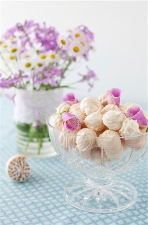 pastel dish - A Glass Footed Bowl Full of Meringue Cookies with Flower Petals; Vase of Flowers in Background Stock Photo - Premium Royalty-Free, Code: 659-07028063