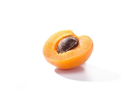 simsearch:659-06184812,k - Half an apricot with the stone in against a white background Stock Photo - Premium Royalty-Free, Code: 659-07028095