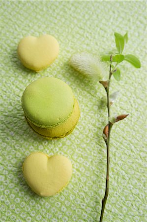 simsearch:659-08940465,k - Lime macaroons, heart-shaped lemon macaroons and a willow catkin Photographie de stock - Premium Libres de Droits, Code: 659-07028160