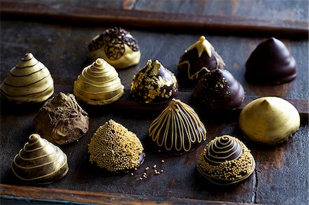 sweet (taste) - Golden pyramid chocolates Stock Photo - Premium Royalty-Free, Code: 659-07028437