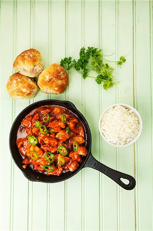 simsearch:659-07027745,k - Spicy turkey goulash in the pan with rice and bread rolls Photographie de stock - Premium Libres de Droits, Code: 659-07028647