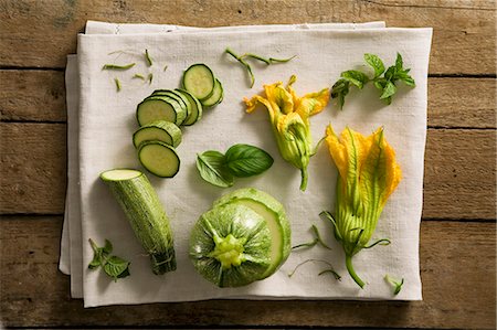 A still life featuring courgettes, courgette flowers and herbs Stock Photo - Premium Royalty-Free, Code: 659-07028671