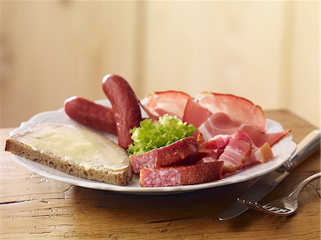 A cold meat platter with a slice of buttered bread Stock Photo - Premium Royalty-Free, Code: 659-07028759