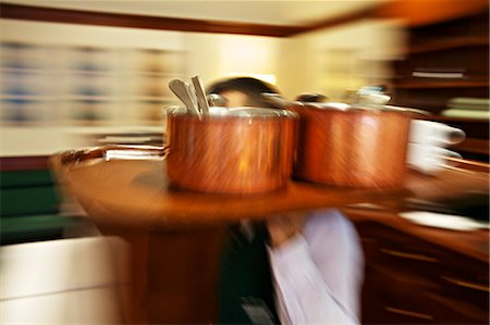 A waiter carrying a tray of copper pots Fotografie stock - Premium Royalty-Free, Codice: 659-07028777