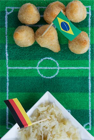 Salgadinhos (Brazil) and sauerkraut (Germany) with football-themed decoration Stock Photo - Premium Royalty-Free, Code: 659-07028920