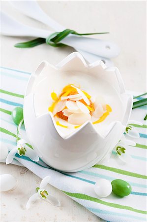 quark food - A yoghurt dessert with passion fruit sauce in an Easter porcelain bowl Stock Photo - Premium Royalty-Free, Code: 659-07028983