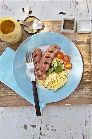 simsearch:659-08513115,k - Grilled bratwurst sausages with white cabbage salad Photographie de stock - Premium Libres de Droits, Code: 659-07068566