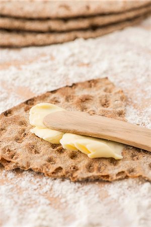 spread - Rye crispbread from Sweden with butter and a wooden knife Stock Photo - Premium Royalty-Free, Code: 659-07068805