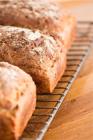 fresh closeup - Freshly baked sourdough bread on a cooling rack Stock Photo - Premium Royalty-Free, Code: 659-07068803