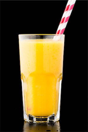 drinking glass black background - A glass of orange juice with bits of pulp Stock Photo - Premium Royalty-Free, Code: 659-07068811