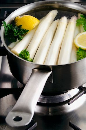 Peeled white asparagus in a saucepan with lemon and parsley Stock Photo - Premium Royalty-Free, Code: 659-07068880