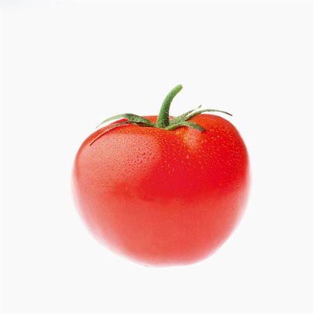 simsearch:659-06307625,k - A tomato with drops of water Foto de stock - Royalty Free Premium, Número: 659-07069034