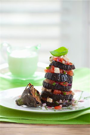 stacked vegetables - A tower of grilled aubergine slices with tomatoes and feta Stock Photo - Premium Royalty-Free, Code: 659-07069169