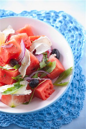 summer salad - Watermelon salad with goat's cheese, red onions, olives and rocket Stock Photo - Premium Royalty-Free, Code: 659-07069177