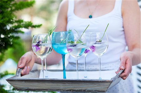 drinks and summer - Lady holding a tray with several glasses of lavender water Stock Photo - Premium Royalty-Free, Code: 659-07069191