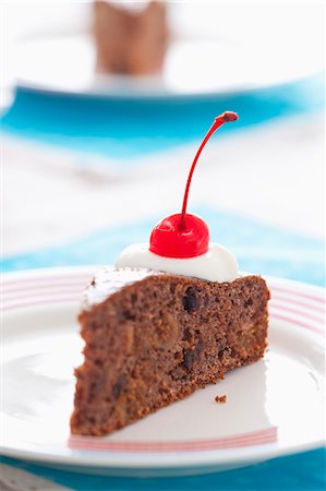 simsearch:659-07598181,k - A slice of chocolate cake with dried fruit, cream and a glacÈ cherry Photographie de stock - Premium Libres de Droits, Code: 659-07069400