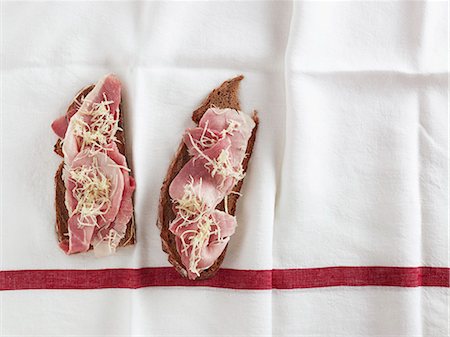 Two slices of bread topped with ham (view from above) Stock Photo - Premium Royalty-Free, Code: 659-07069421