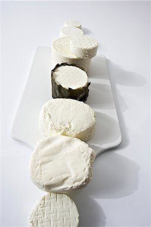 simsearch:659-03531118,k - Assorted types of fresh goat's cheese laid out in a row Photographie de stock - Premium Libres de Droits, Code: 659-07069464