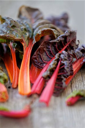 silver beet - Red chard leaves on a wooden surface Stock Photo - Premium Royalty-Free, Code: 659-07069472