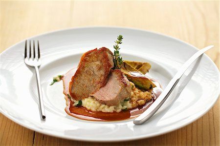 simsearch:659-08419571,k - Veal tenderloin with avocado wedges and lemon risotto Stock Photo - Premium Royalty-Free, Code: 659-07069569