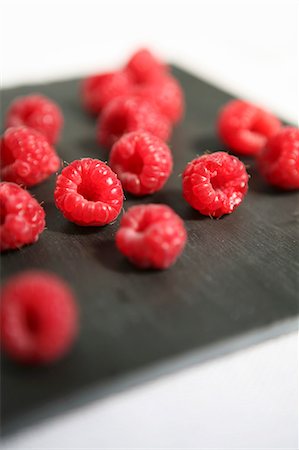 fruit studio white background focus - Raspberries on a black board Stock Photo - Premium Royalty-Free, Code: 659-07069727