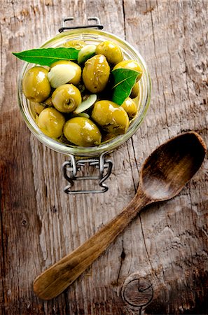 pickle - Preserved olives on a wooden surface Stock Photo - Premium Royalty-Free, Code: 659-07069803