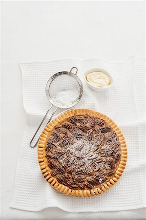 sweet pastry - Pecan pie with icing sugar (view from above) Stock Photo - Premium Royalty-Free, Code: 659-07069850