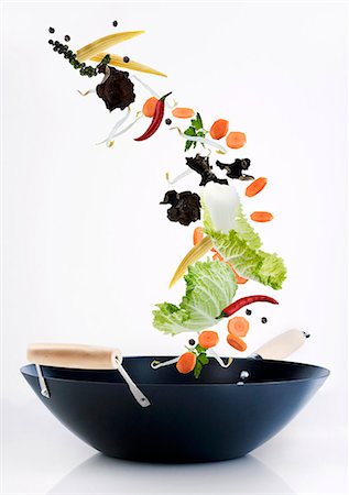 speciality - Ingredients for an Asian vegetable dish falling into a wok Stock Photo - Premium Royalty-Free, Code: 659-07069888
