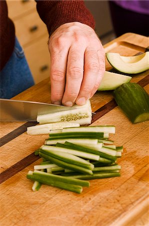 Man Slicing Cucumber into Sticks Stock Photo - Premium Royalty-Free, Code: 659-07596984