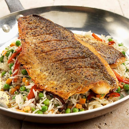 simsearch:659-06185095,k - Pan Seared White Lake Bass on Bed of Rice and Vegetables Stock Photo - Premium Royalty-Free, Code: 659-07597021