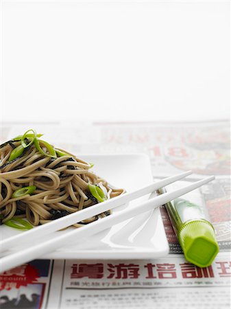 Japanese soba noodles on a white plate with white chopsticks Stock Photo - Premium Royalty-Free, Code: 659-07597051