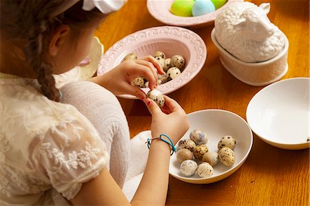 easter celebration - A girl peeling quail's eggs Stock Photo - Premium Royalty-Free, Code: 659-07597197