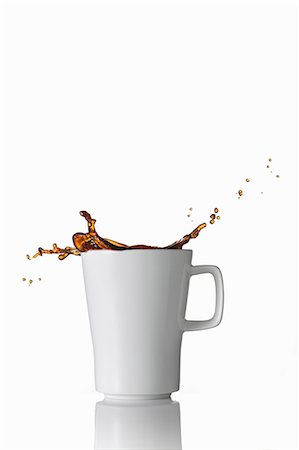 dripping coffee - Black coffee splashing out of the mug Stock Photo - Premium Royalty-Free, Code: 659-07597254