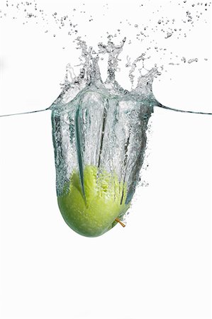 simsearch:659-06186831,k - A green apple falling into water Photographie de stock - Premium Libres de Droits, Code: 659-07597250