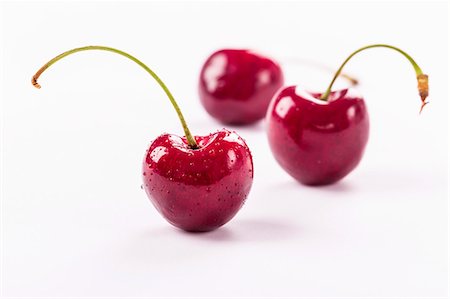 stone fruit - Three cherries with drops of water Stock Photo - Premium Royalty-Free, Code: 659-07597270