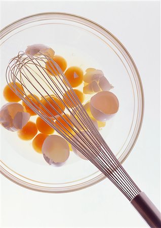 simsearch:640-02953268,k - A glass bowl with raw eggs, eggshells and a balloon whisk Stock Photo - Premium Royalty-Free, Code: 659-07597856