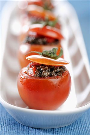 simsearch:659-06372447,k - Detail of cherry tomatoes stuffed with tapenade of peppers (vertical) Stock Photo - Premium Royalty-Free, Code: 659-07598111