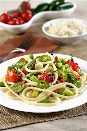 spaghettis - Bucatoni with asparagus, cherry and jalapeno (vertical) Stock Photo - Premium Royalty-Free, Code: 659-07598122