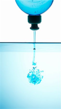 running water bottle - Blue washing-up liquid running into water Stock Photo - Premium Royalty-Free, Code: 659-07598234